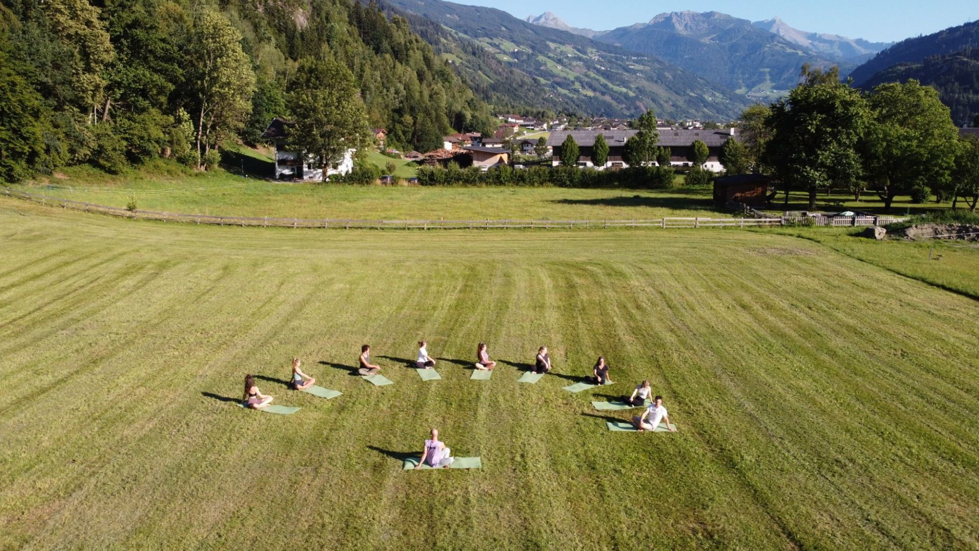 Yoga auf einer Wiese inmitten der Zillertaler Berglandschaft